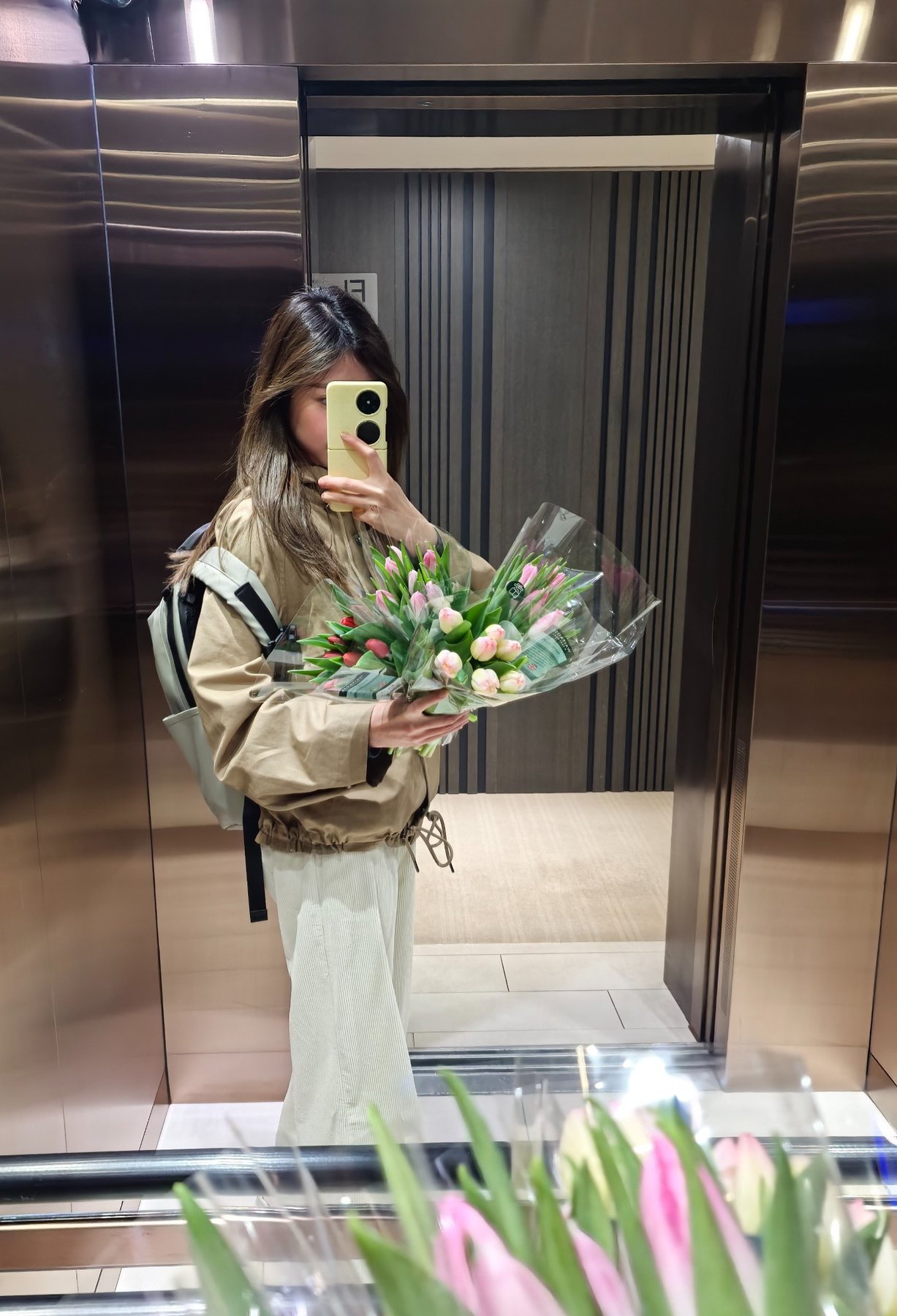 A mirror photograph with a bouquet of pink and white tulips.